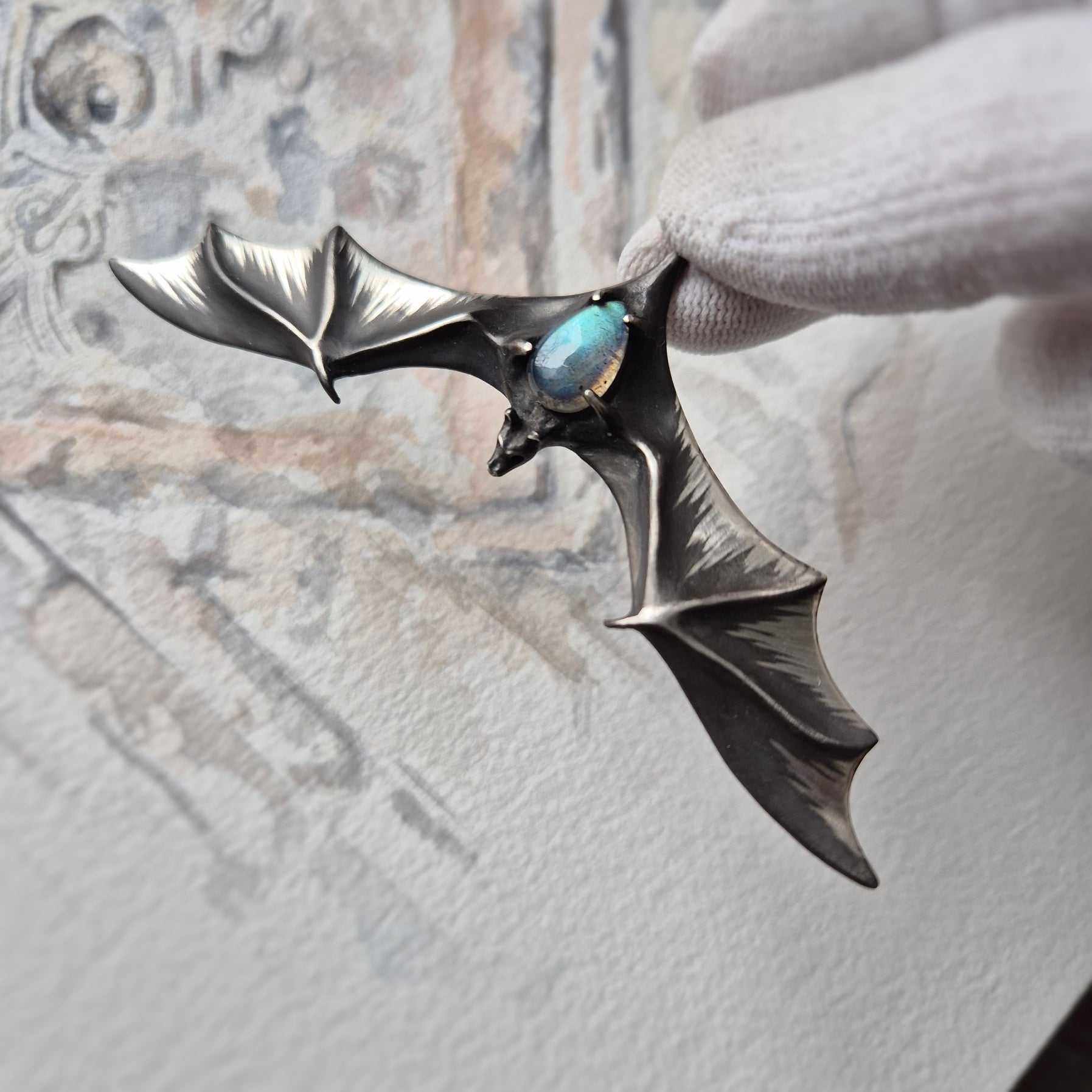 Silver Bat Pendant with Blue Labradorite, Handmade Gothic Talisman. In hand top left view